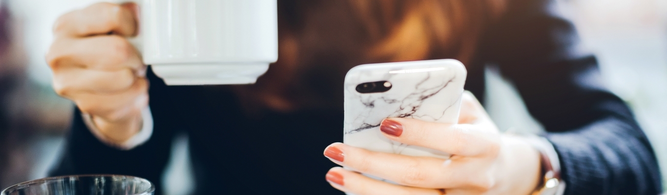 Woman with Coffee Mug and Phone